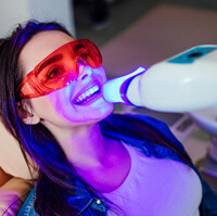 a woman receiving in-office teeth whitening
