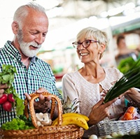 elderly couple buying fresh produce