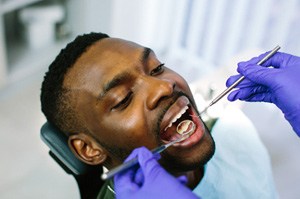 a man having his teeth examined by a dentist