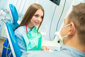 Woman learning cost of treating dental emergencies in Plano, TX.