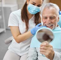 Patient smiling with an implant dentist in Plano