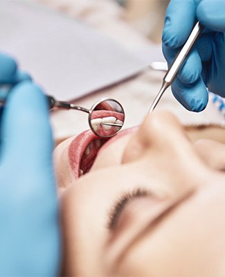 Closeup of woman’s face undergoing dental exam