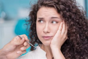 woman with a toothache called the emergency dentist Plano loves