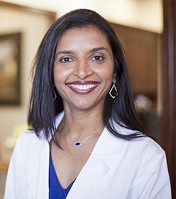 Dr. Anita Madhav, dentist in Plano, smiling at camera