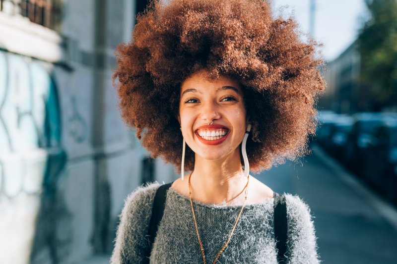 person with nice teeth thanks to dental implants smiling