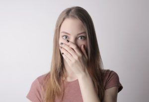 Woman embarrassed by stains covering her mouth