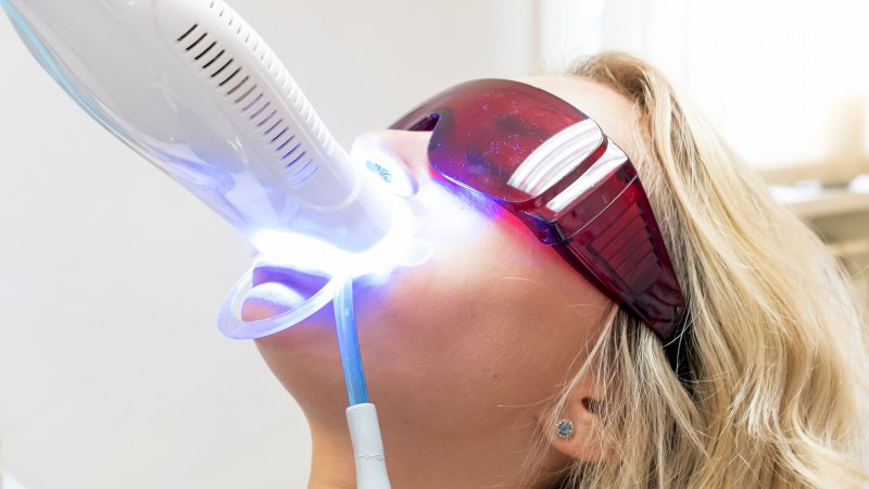 person with stained teeth having them whitened by dentist