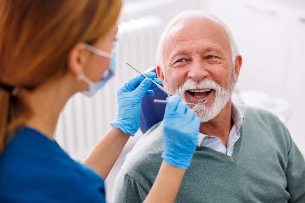 Man smiles after dental bridge repair